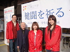 「健闘を祈る」の横断幕の前で